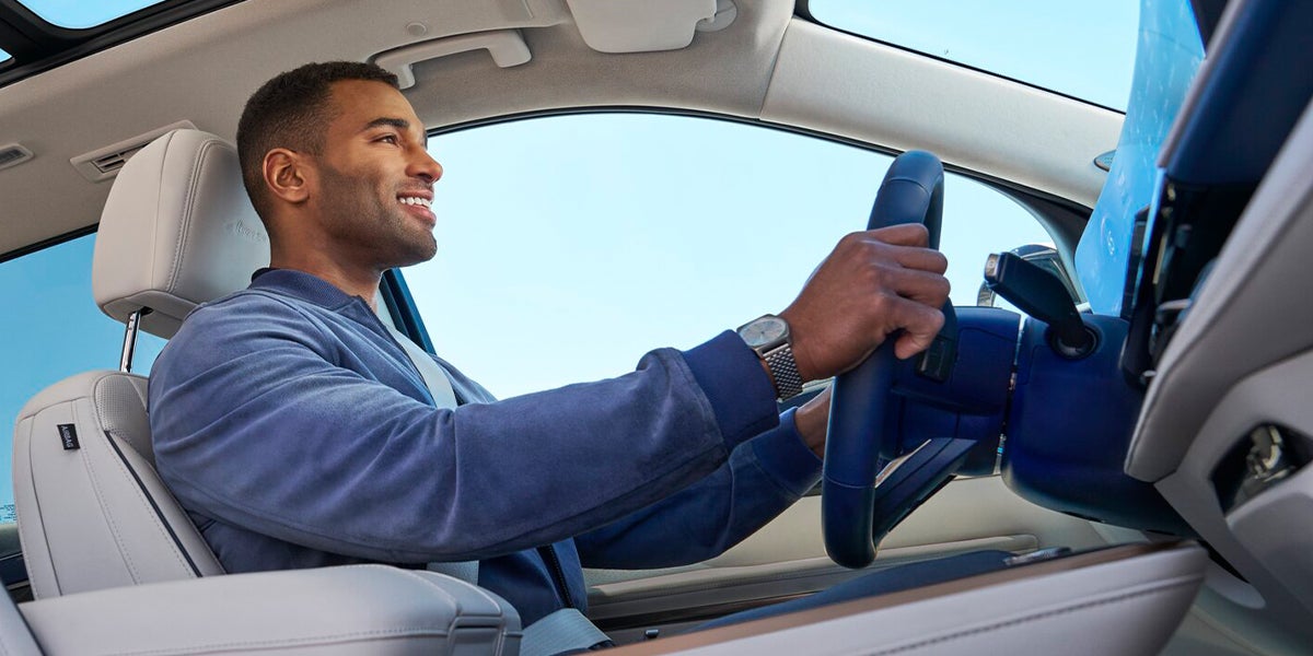 Driver enjoying vehicle panoramic roof interior view
