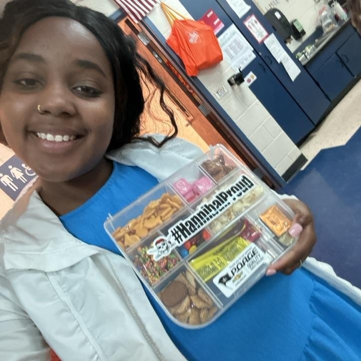 community member holding snack box