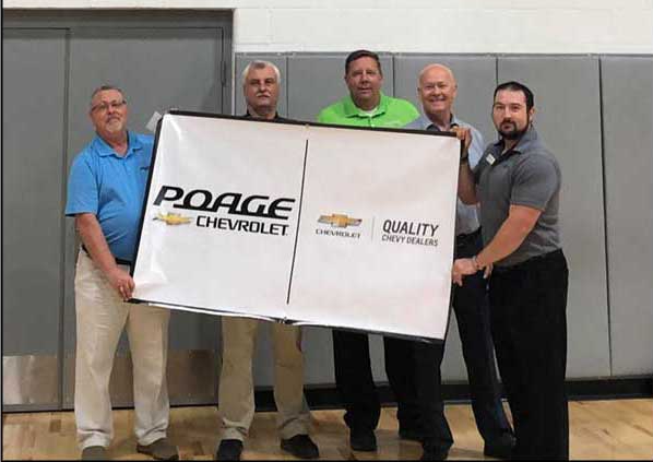 Poage Chevrolet Buick members holding giant check with community members